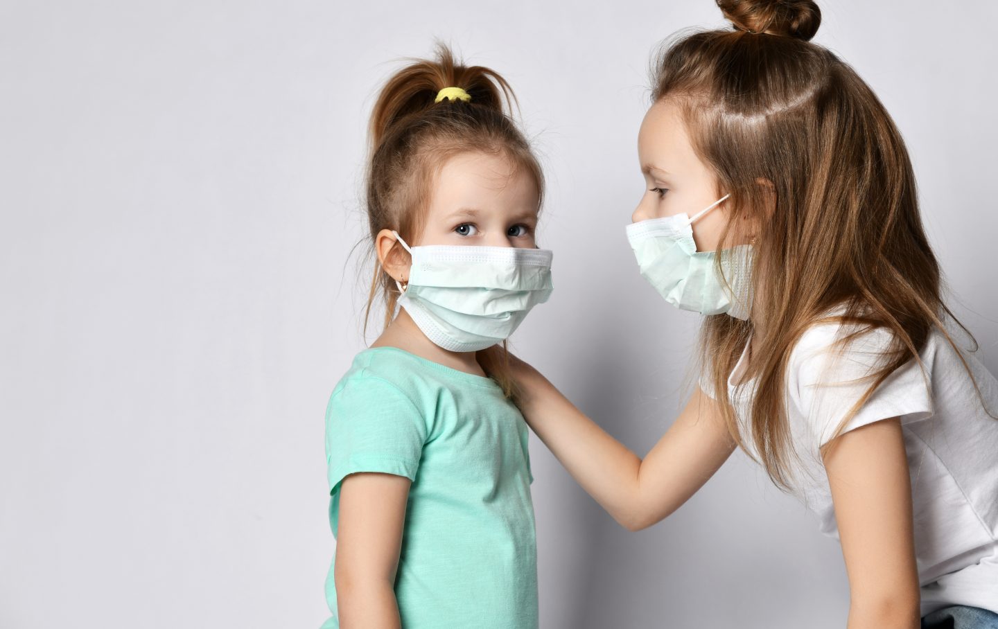 Two children girls kids are afraid of the disease in protection masks from the Coronavirus Covid-19