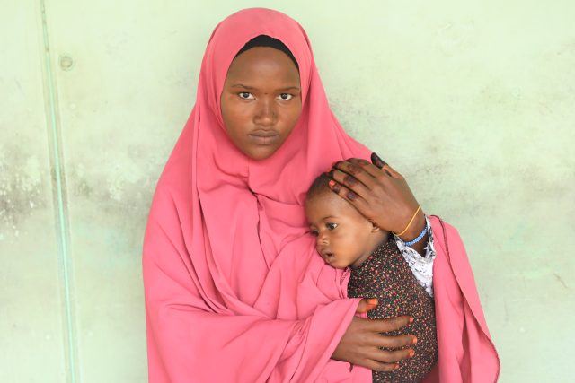 Somalia ERP Mogadishu mother Anab holding child at SOS hospital